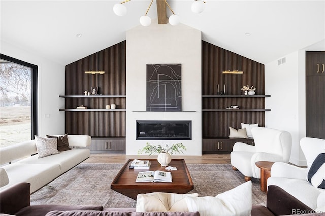 living area with built in shelves, wood finished floors, visible vents, high vaulted ceiling, and a fireplace