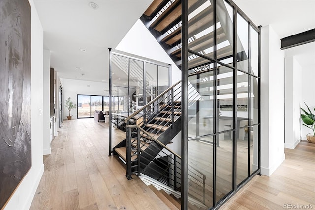 staircase with baseboards and wood-type flooring