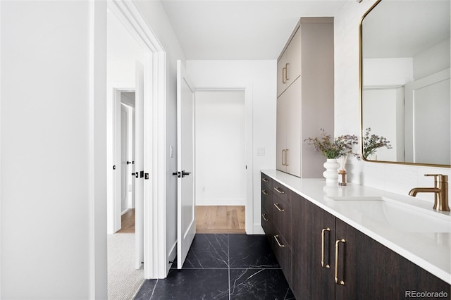 bathroom featuring marble finish floor and vanity