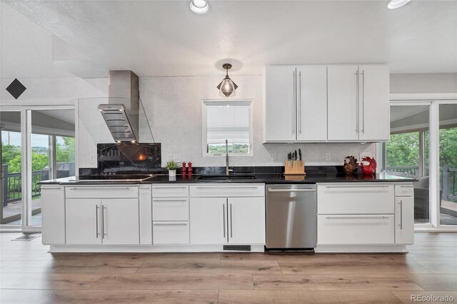 9053 Clydesdale Rd, Castle Rock, CO 80108 - kitchen with stainless steel dishwasher, a sink, white cabinetry, dark countertops, and backsplash