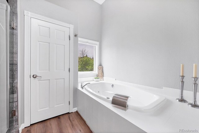 9053 Clydesdale Rd, Castle Rock, CO 80108 - bathroom with a jetted tub and wood finished floors