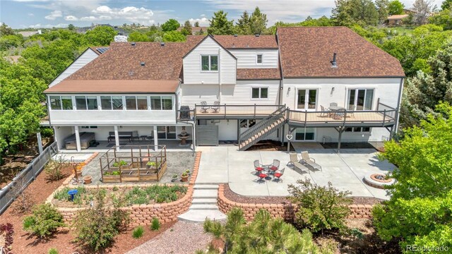9053 Clydesdale Rd, Castle Rock, CO 80108 - rear view of house with a patio area, a deck, stairway, and roof with shingles