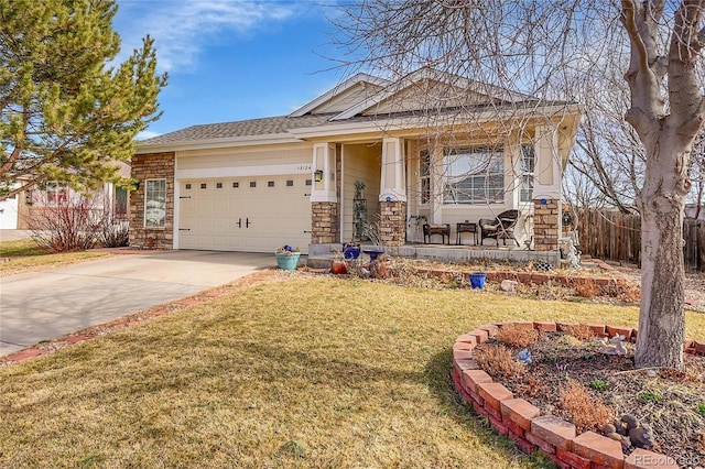 view of front of property featuring driveway, a garage, stone siding, covered porch, and a front lawn