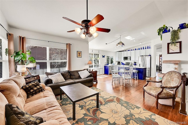 living room featuring ceiling fan and light wood-type flooring