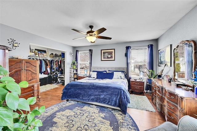 bedroom featuring ceiling fan, a closet, and wood finished floors