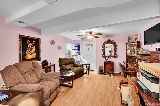 living area featuring light wood-style flooring, visible vents, and a ceiling fan