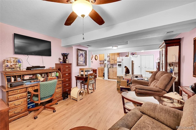 living room featuring light wood-type flooring and ceiling fan