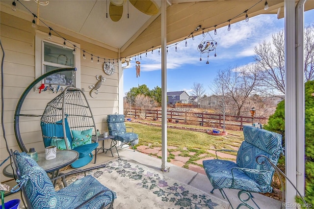 view of patio / terrace with ceiling fan and fence