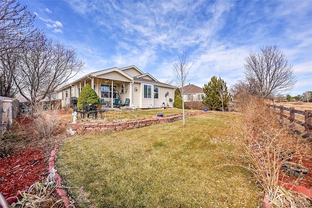 back of house featuring a yard, a patio, and a fenced backyard