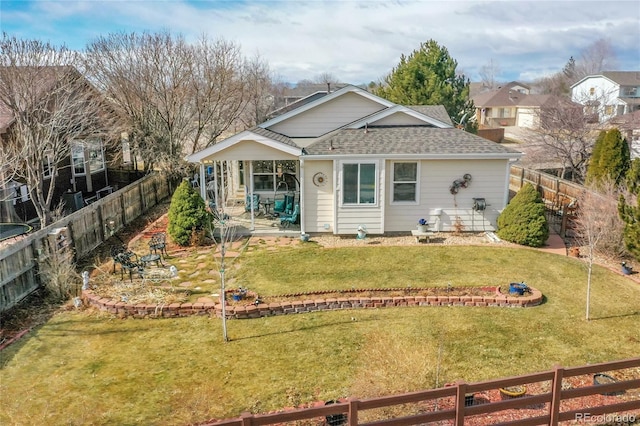 back of house featuring a patio area, a fenced backyard, and a lawn