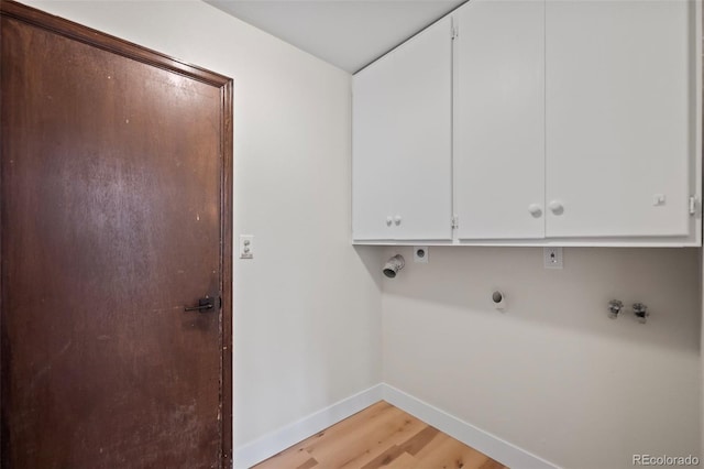 laundry area featuring light wood-type flooring, hookup for a washing machine, cabinets, and electric dryer hookup