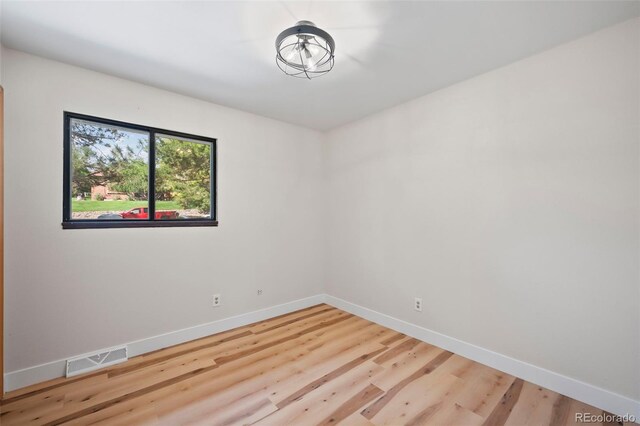 spare room featuring light wood-type flooring