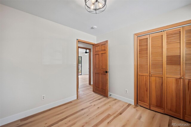 unfurnished bedroom featuring light hardwood / wood-style flooring and a closet