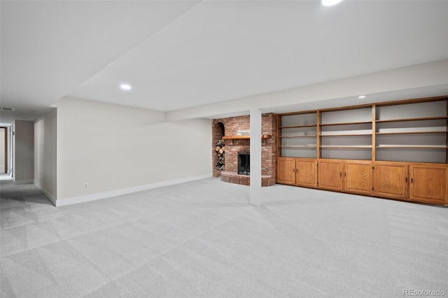 unfurnished living room featuring light carpet, visible vents, a fireplace, and baseboards