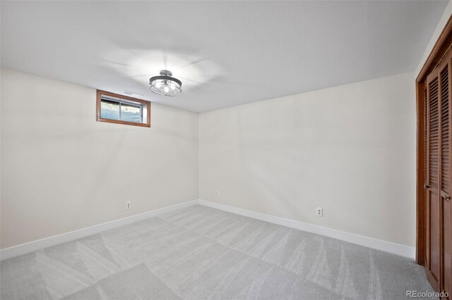 unfurnished bedroom with light colored carpet and a closet