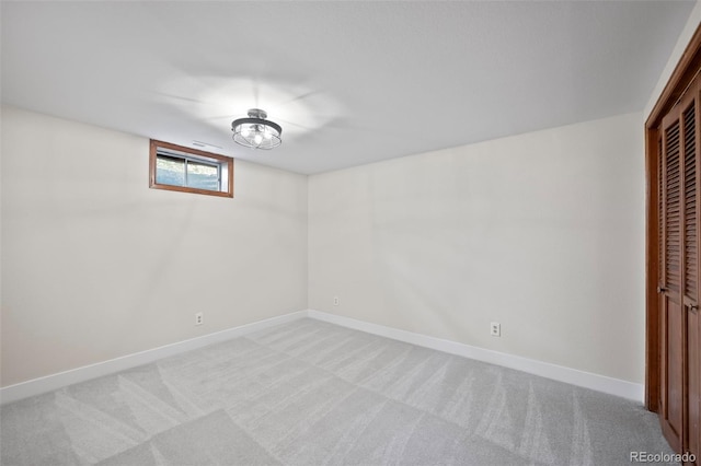 interior space featuring baseboards and light colored carpet