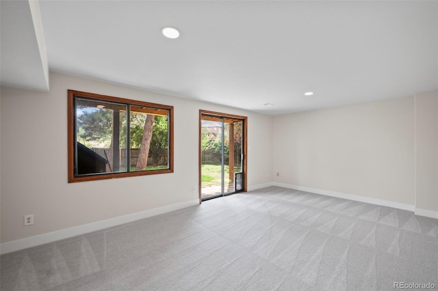 unfurnished room with light carpet, baseboards, and recessed lighting