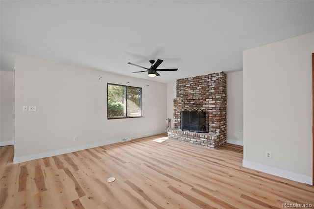 unfurnished living room featuring a fireplace, light wood finished floors, visible vents, ceiling fan, and baseboards