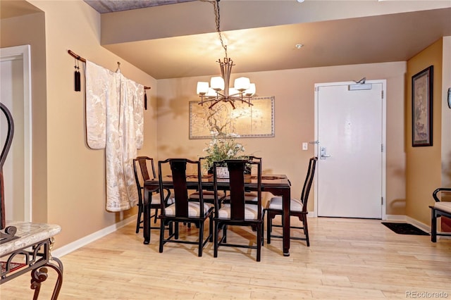 dining space with a chandelier and light hardwood / wood-style floors