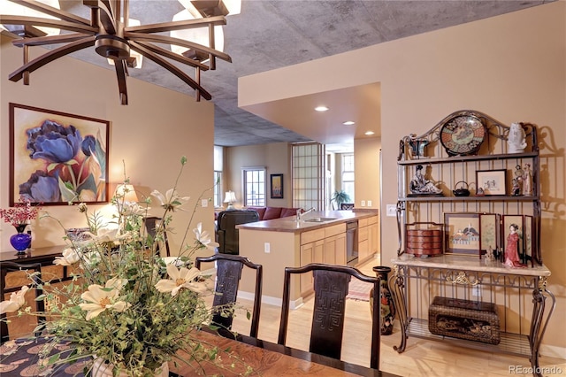 kitchen with ceiling fan, light wood-type flooring, sink, and stainless steel dishwasher