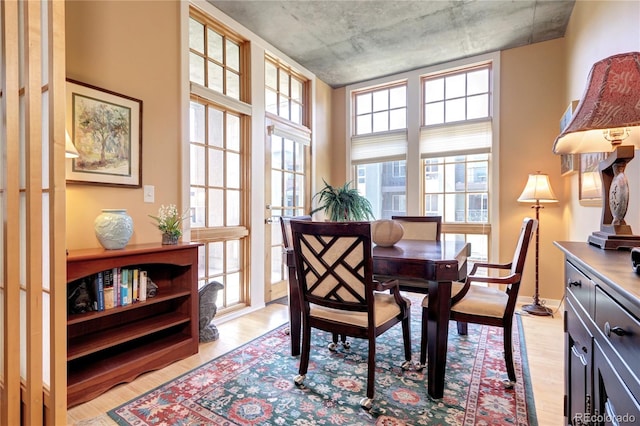 dining space featuring plenty of natural light and light hardwood / wood-style floors