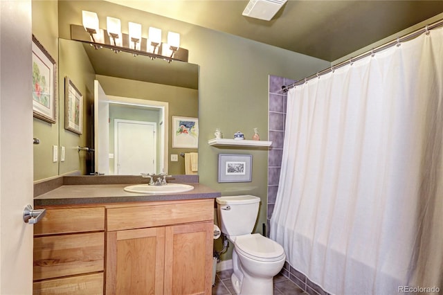 bathroom with a shower with shower curtain, tile patterned floors, vanity, and toilet