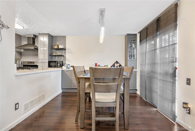 dining area featuring dark hardwood / wood-style floors