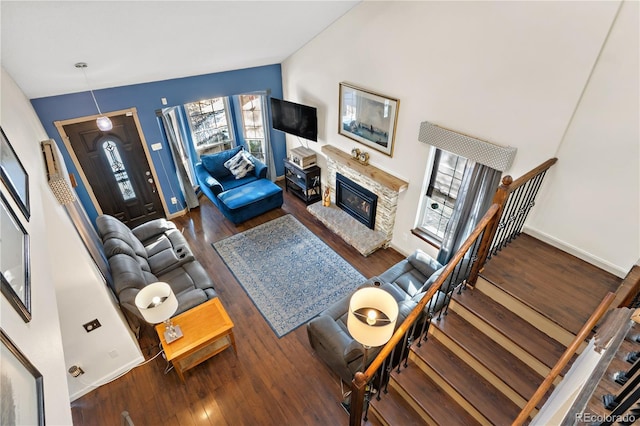 living room with vaulted ceiling and dark wood-type flooring