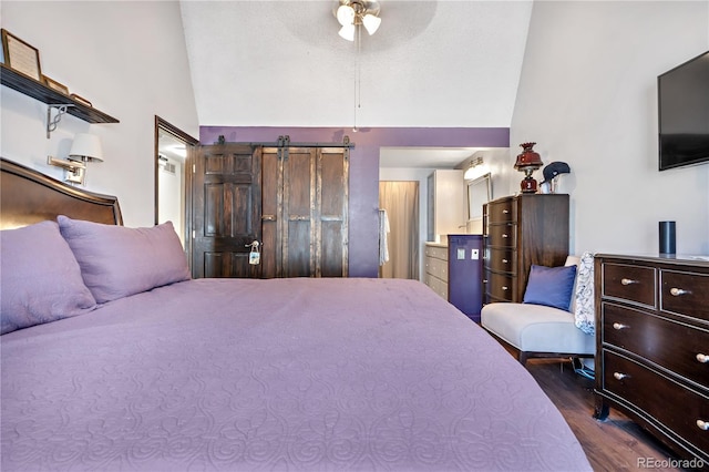 bedroom with dark wood-type flooring, connected bathroom, and vaulted ceiling