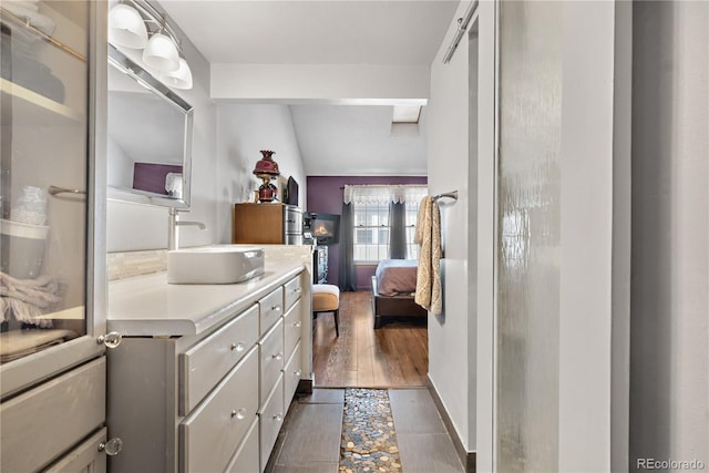 bathroom with vanity and lofted ceiling