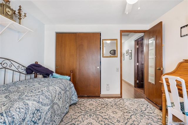 bedroom with ceiling fan, a closet, and light hardwood / wood-style flooring