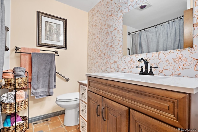 bathroom featuring vanity, toilet, curtained shower, and tile patterned flooring