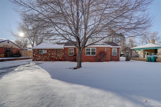 view of snow covered back of property