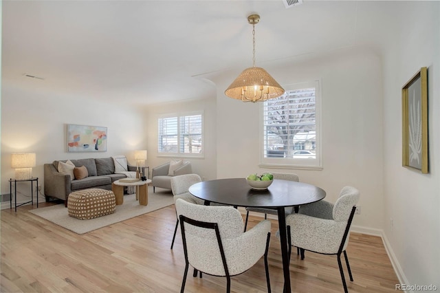 dining space with a wealth of natural light and hardwood / wood-style floors