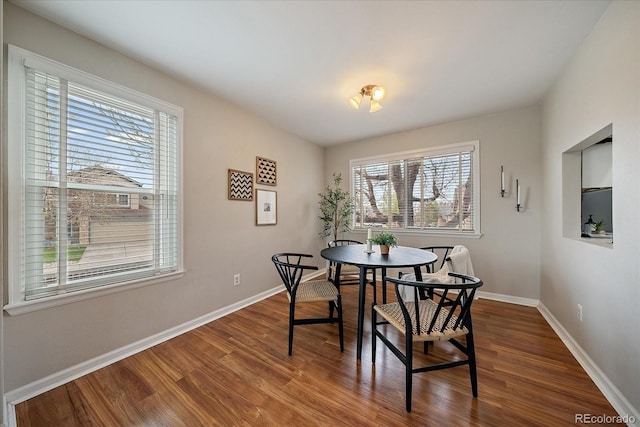 dining room with dark wood finished floors and baseboards