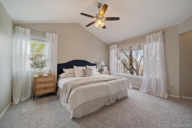 carpeted bedroom with lofted ceiling, ceiling fan, and baseboards