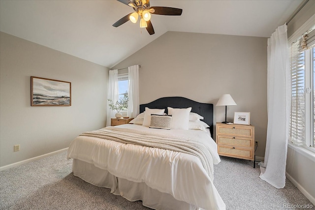 carpeted bedroom featuring vaulted ceiling, multiple windows, baseboards, and ceiling fan