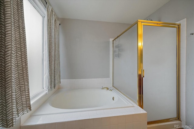 full bathroom with a bath and a stall shower