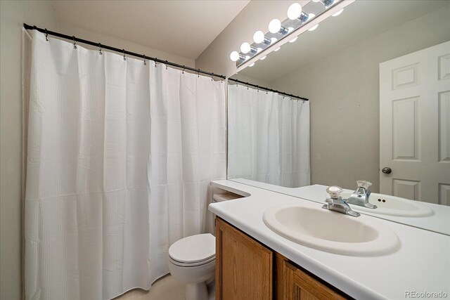 full bathroom with toilet and vanity