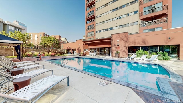 view of swimming pool with a gazebo and a patio