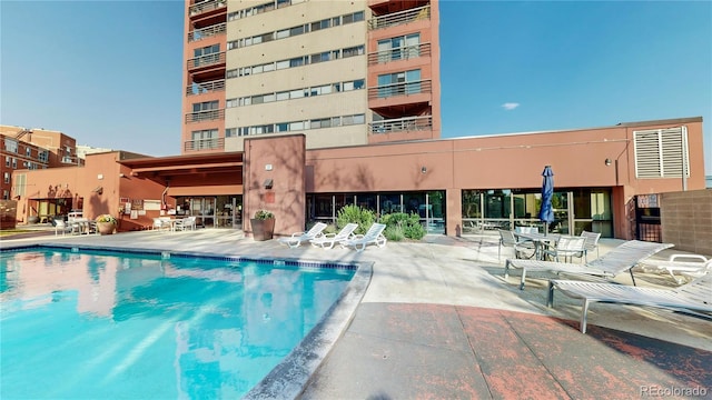 view of swimming pool with a patio area