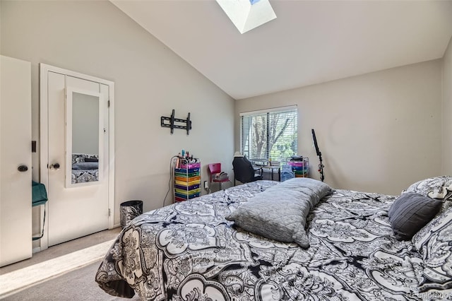 carpeted bedroom featuring vaulted ceiling with skylight