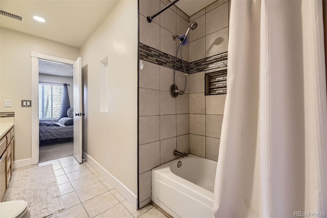 bathroom with tile patterned floors, visible vents, baseboards, ensuite bath, and vanity