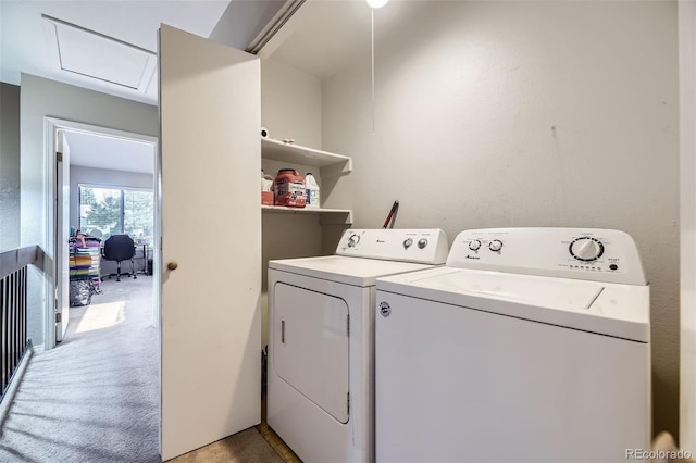 clothes washing area with light colored carpet, separate washer and dryer, attic access, and laundry area