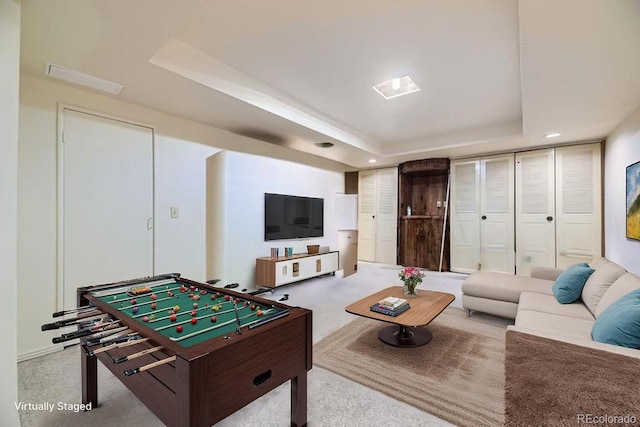 rec room featuring a tray ceiling, carpet flooring, and recessed lighting