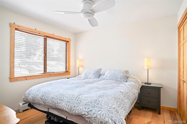 150 Evergreen Rd Unit 204, Dillon, CO 80435 - bedroom with light wood finished floors, a baseboard radiator, baseboards, and a closet