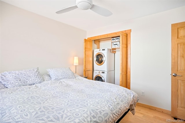 150 Evergreen Rd Unit 204, Dillon, CO 80435 - bedroom with stacked washer / dryer, light wood finished floors, ceiling fan, and baseboards
