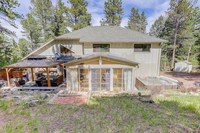 8795 Rudd Rd, Evergreen, CO 80439 - back of property featuring a sunroom, a gazebo, a storage shed, an outdoor structure, and a shingled roof