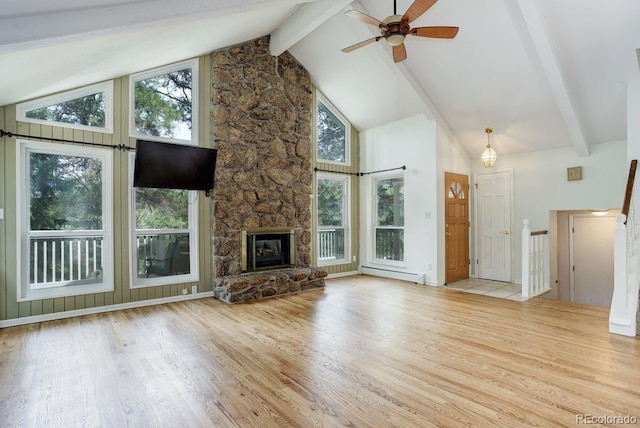 8795 Rudd Rd, Evergreen, CO 80439 - unfurnished living room featuring a baseboard heating unit, beam ceiling, wood finished floors, healthy amount of natural light, and high vaulted ceiling