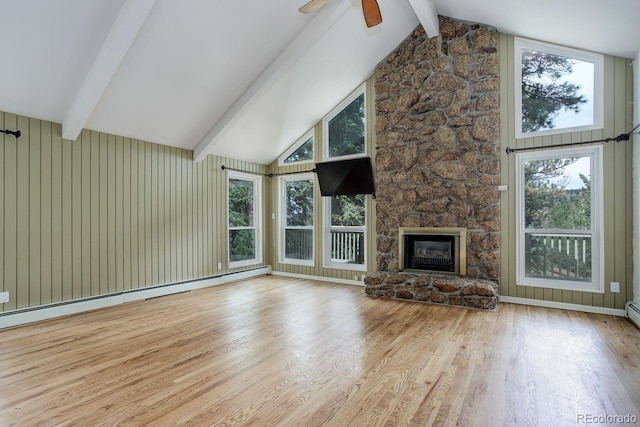 8795 Rudd Rd, Evergreen, CO 80439 - unfurnished living room featuring a baseboard radiator, wood finished floors, ceiling fan, and a stone fireplace